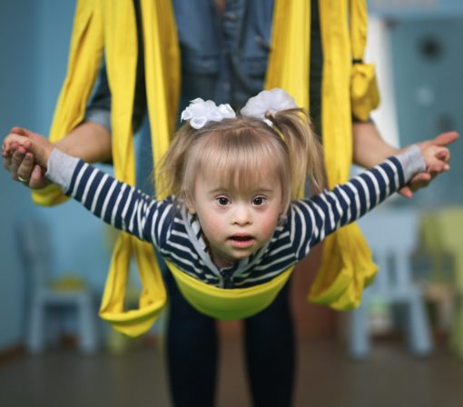 Child stretching with therapist